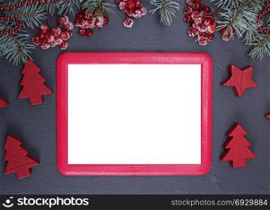 empty red frame on a black background in the middle of a Christmas decor