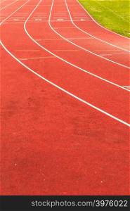 Empty red running track in stadium closeup. Red running track in stadium.