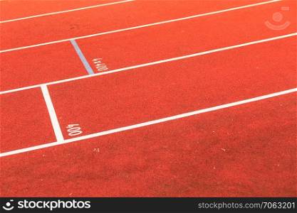 Empty red running track in stadium closeup. Red running track in stadium.