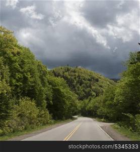 Empty road amidst trees in forest, Cabot Trail, Cape Breton Highlands National Park, Cape Breton Island, Nova Scotia, Canada