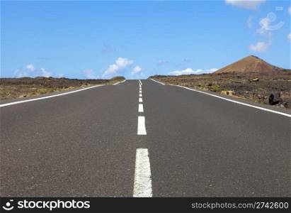 Empty road an arid mountain, Lanzarote, Canary islands, Spain