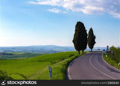 empty road and green hill in Tuscany, Italy