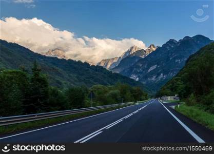 Empty road in the Alps valley, Italy.. Empty road in the Alps valley, Italy
