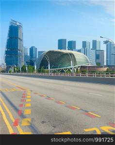 Empty road, modern skyscrapers and Esplanade Theatres on the Bay in Singapore