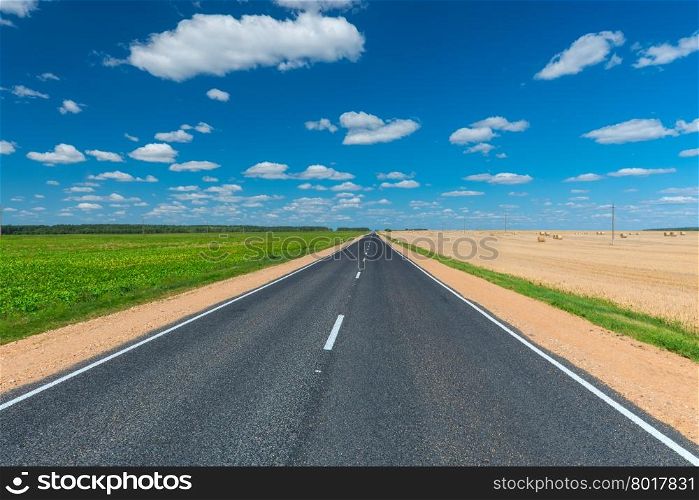 empty road on either side cultivated fields