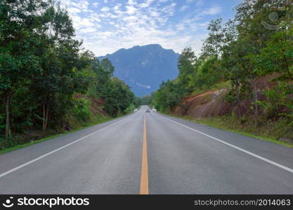 Empty road or street to Doi Luang Chiang Dao, Chiang Mai on mountain hill with green natural forest trees in rural area, Thailand. Transportation. Nature landscape background