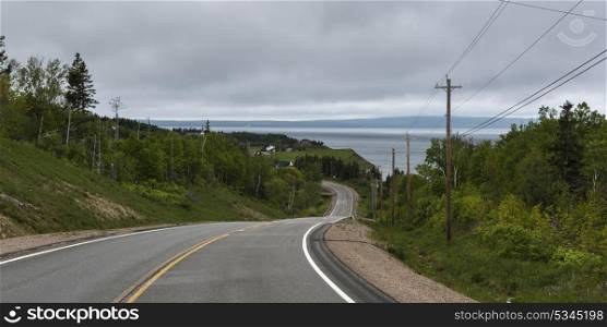 Empty road passing through rural landscape, Grand River, Cape Breton Island, Nova Scotia, Canada