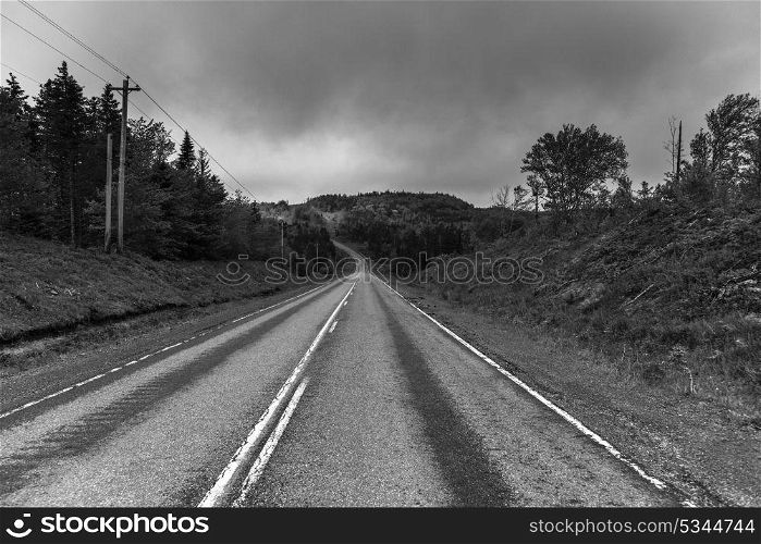 Empty road passing through rural landscape, St. Peter&rsquo;s, Cape Breton Island, Nova Scotia, Canada