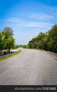 Empty road quiet in summer / Curve road winding street countryside to the forest