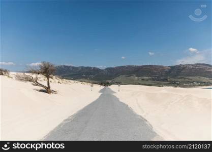 empty road sands against mountains