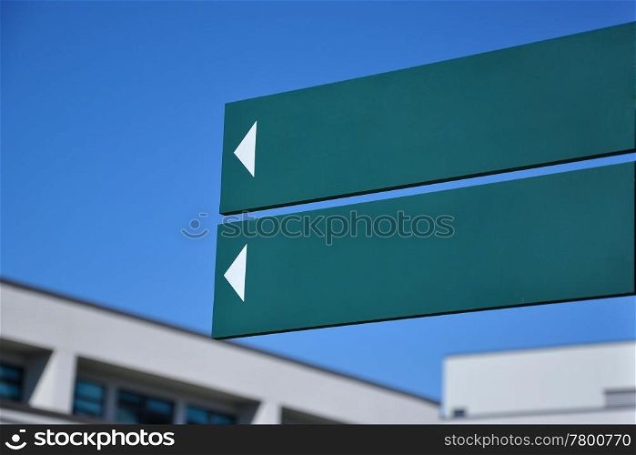 Empty road sign in front of building