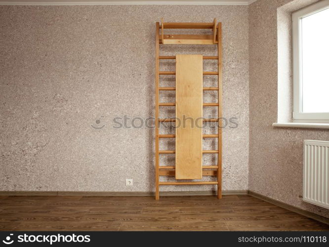 empty room for gymnastics with wall mounted gym ladder