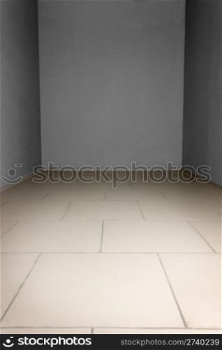 Empty room with grey and stone tiles at the floor. Background