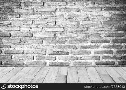 empty room with red brick wall and wooden floor