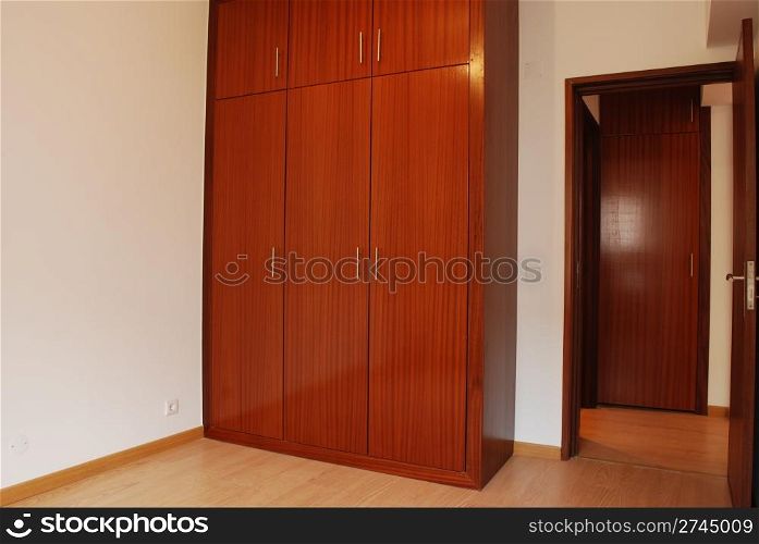 empty room with wooden wardrobe and floor