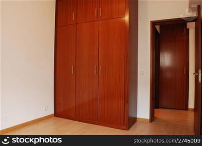 empty room with wooden wardrobe and floor