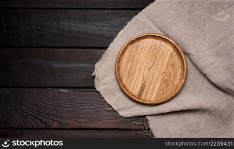 empty round brown wooden plate on table, top view