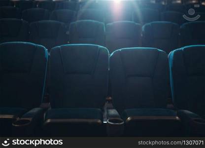 Empty rows of seats in cinema or theater, nobody, no people. Showtime, entertainment industry. Empty rows of seats in cinema or theater