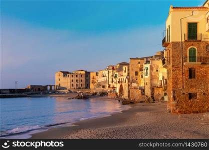 Empty sand beach in old town of coastal city Cefalu at sunset, Sicily, Italy. Cefalu at sunset, Sicily, Italy