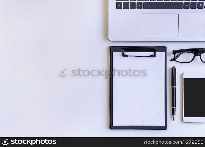 Empty screen Smart phone and tablet with laptop on business desk office with copy space, Top view