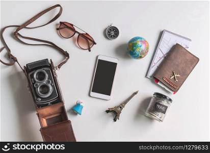 Empty screen smart phone with travel accessories and items on white background with copy space, Travel concept