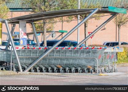 empty shopping carts stacked together in a parking lot