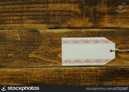 Empty shopping tag template on a rustic wood background