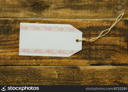 Empty shopping tag template on a rustic wood background