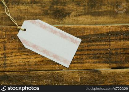 Empty shopping tag template on a rustic wood background