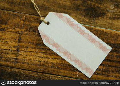 Empty shopping tag template on a rustic wood background