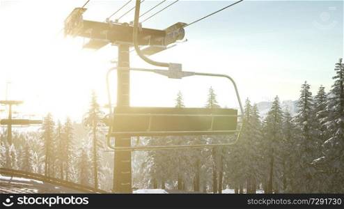 empty ski lift. chairlift silhouette on high mountain over the forest at sunset