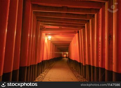 Empty space in Fushimi Inari Taisha temple in travel holidays vacation trip concept in outdoor in Kyoto, Japan. Red poles in the temple. Walkway tunnel of shrine. Structure architecture background.