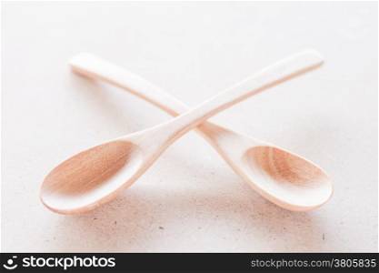Empty spoons on brown background, stock photo