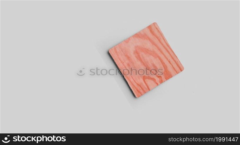 Empty square cork coaster, isolated on grey background. Perfect as food display.