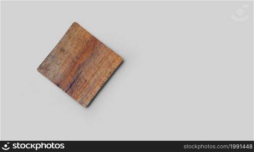 Empty square cork coaster, isolated on grey background. Perfect as food display.