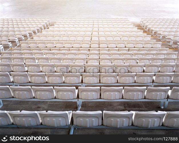 Empty stadium seats in row viewed from behind.. Empty indoor stadium seats
