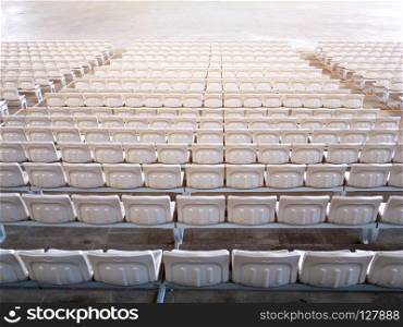 Empty stadium seats in row viewed from behind.. Empty indoor stadium seats