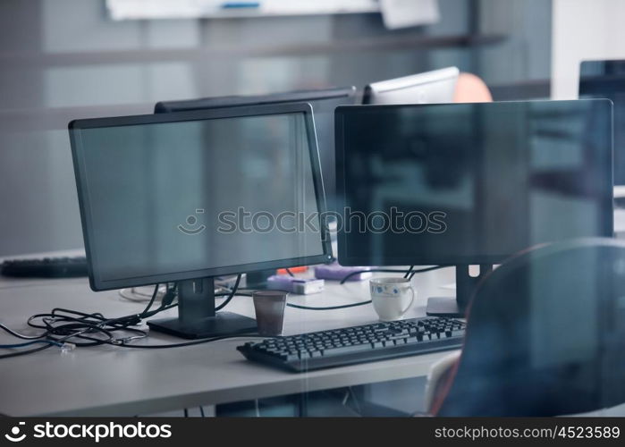 empty startup office interior with modern computers and dual screen monitors