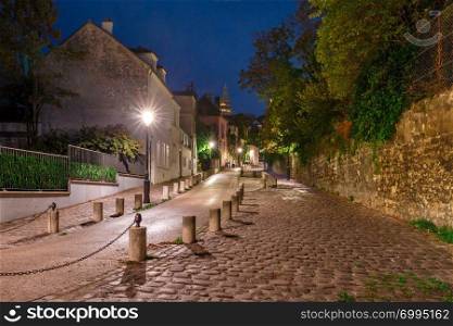Empty street and the Sacre-Coeur at night, quarter Montmartre in Paris, France. Montmartre in Paris, France