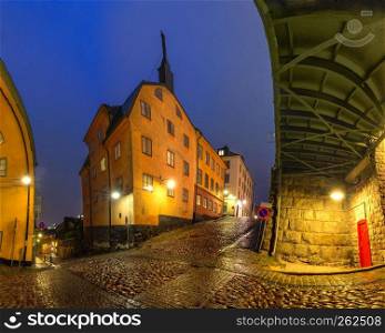 Empty street in Old Town of Stockholm in the rainy night, the capital of Sweden. Night street in Stockholm, Sweden