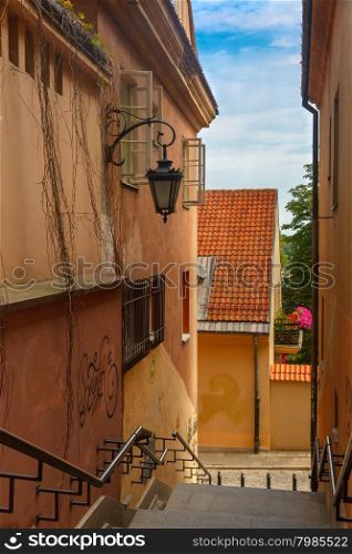 Empty street with stairs and lantern in the Old Town of Warsaw in the summer sunny day, Poland