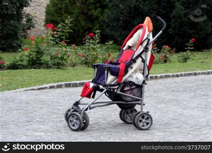 Empty stroller at a park in summer