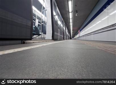 Empty subway trainl waiting at a deserted platform