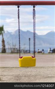 Empty swing with yellow and red colors in Antalya