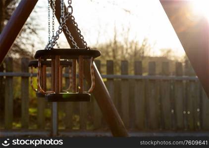 Empty Swings at Childrens Playground Closed Due to Coronavirus COVID-19 Pandemic at Sunset
