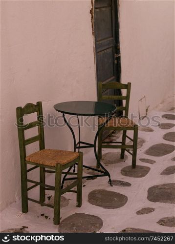 Empty table and chairs in Mykonos Greece