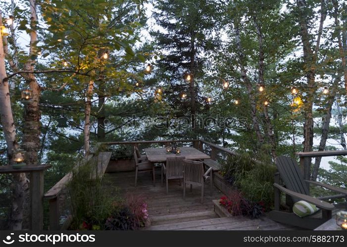 Empty table and chairs on a deck, Lake of the Woods, Ontario, Canada