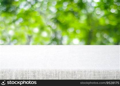 Empty table and sack tablecloth over blur park background, for product display montage