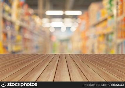 Empty table board with bokeh blurry background of aisle of label products on shelves at supermarket or grocery store. Food shopping. Lifestyle. Abstract