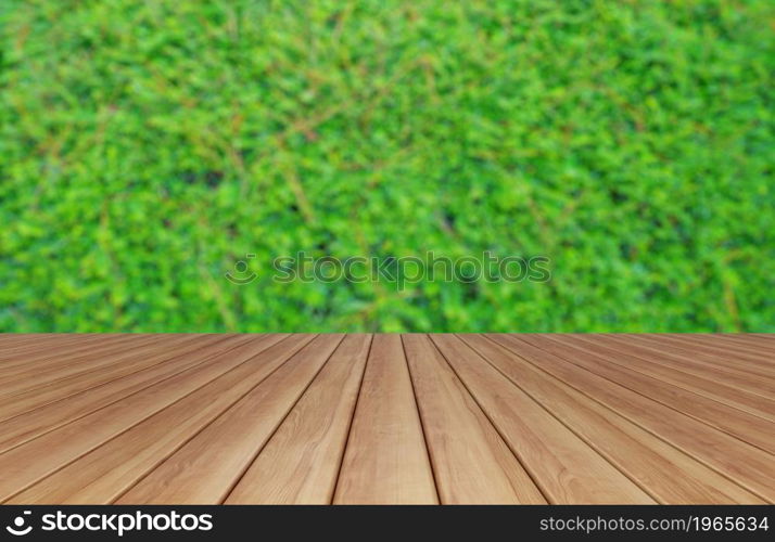 Empty table board with vertical garden lush green grass wall pattern surface texture. Close-up of exterior natural material for design. Bushes trees plants growing.